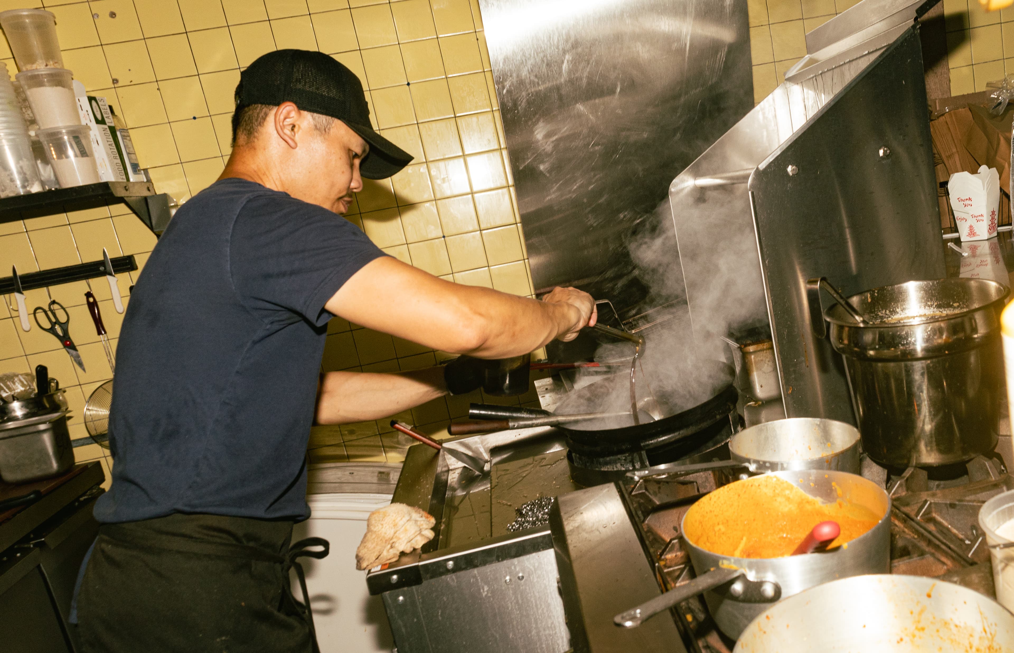 Chef Ono cooking over high flame wok